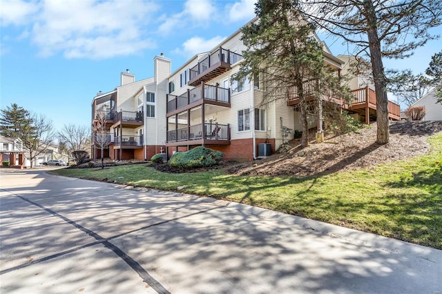 view of property with a residential view and central AC unit