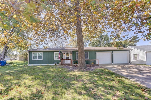 ranch-style home with an attached garage, driveway, a front lawn, and fence