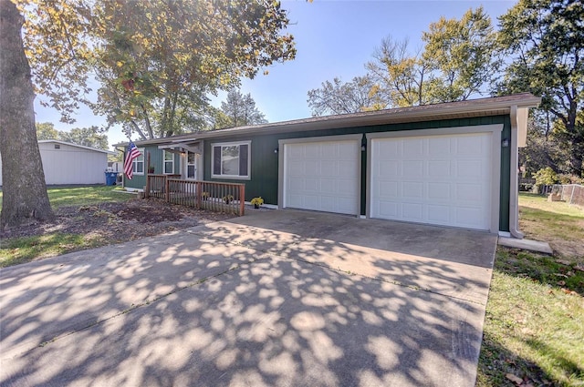 single story home featuring a garage and driveway