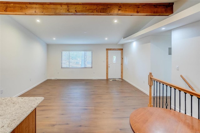 interior space with visible vents, baseboards, beamed ceiling, recessed lighting, and light wood-style flooring