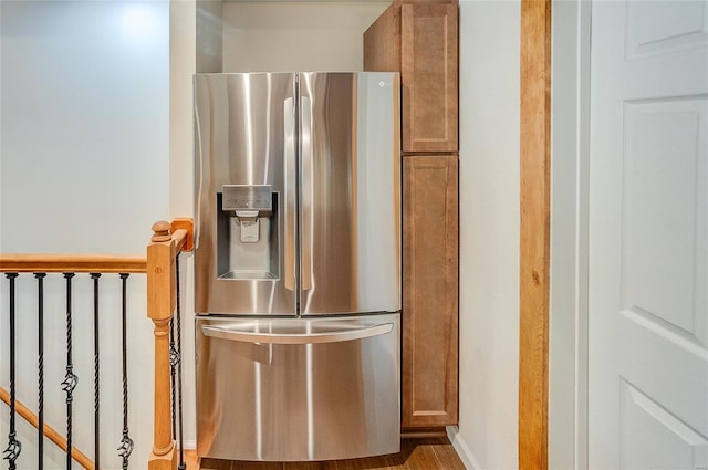 interior details with brown cabinetry and stainless steel refrigerator with ice dispenser