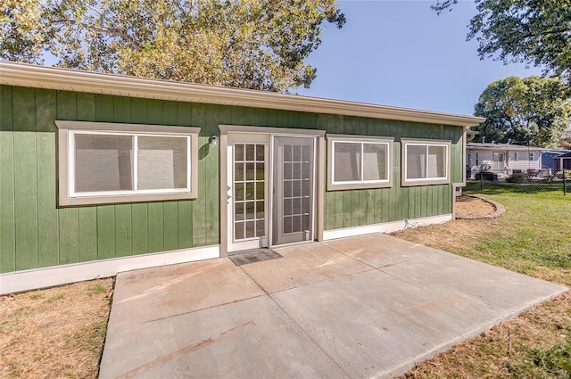 exterior space with a patio area, a lawn, and fence