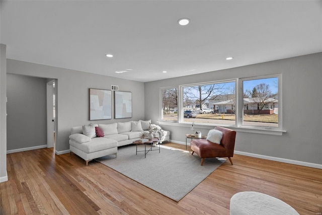 living room with visible vents, recessed lighting, baseboards, and wood finished floors