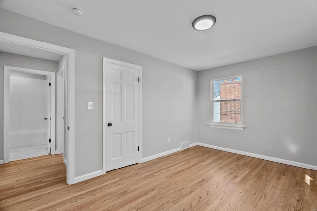 unfurnished bedroom with visible vents, baseboards, and light wood finished floors