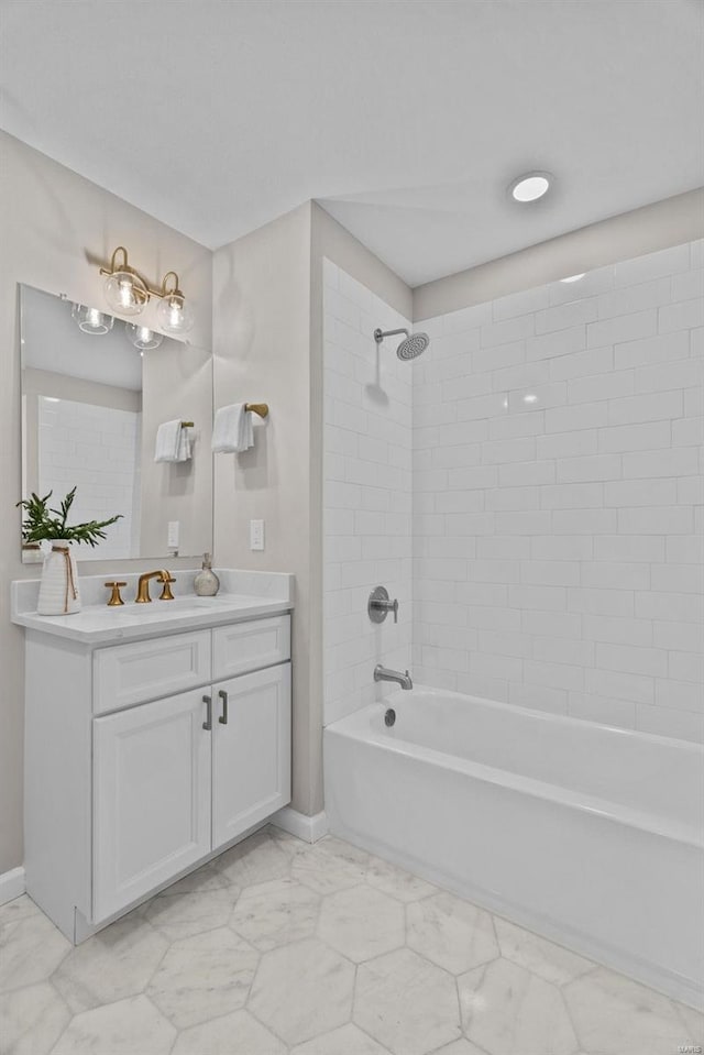 full bathroom featuring vanity, shower / tub combination, baseboards, and marble finish floor