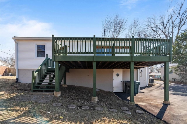 back of property featuring stairs, a deck, and cooling unit