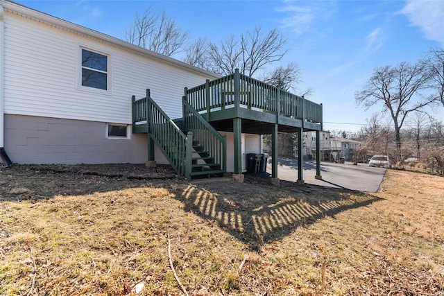 back of property featuring a patio, stairway, and a wooden deck