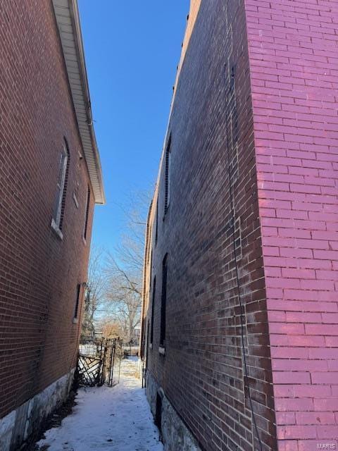 view of side of home with brick siding