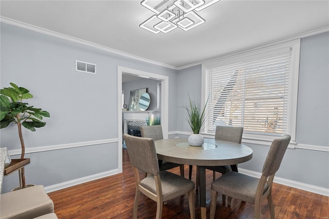 dining space featuring wood finished floors, visible vents, and baseboards