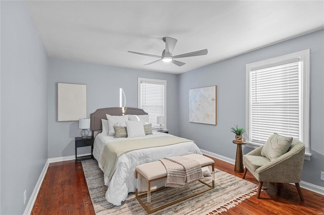 bedroom featuring ceiling fan, baseboards, and wood finished floors