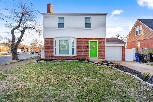 colonial-style house with brick siding, a front lawn, fence, concrete driveway, and a garage