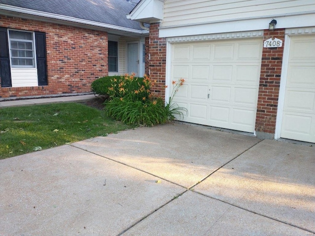 exterior space with brick siding, concrete driveway, and a shingled roof