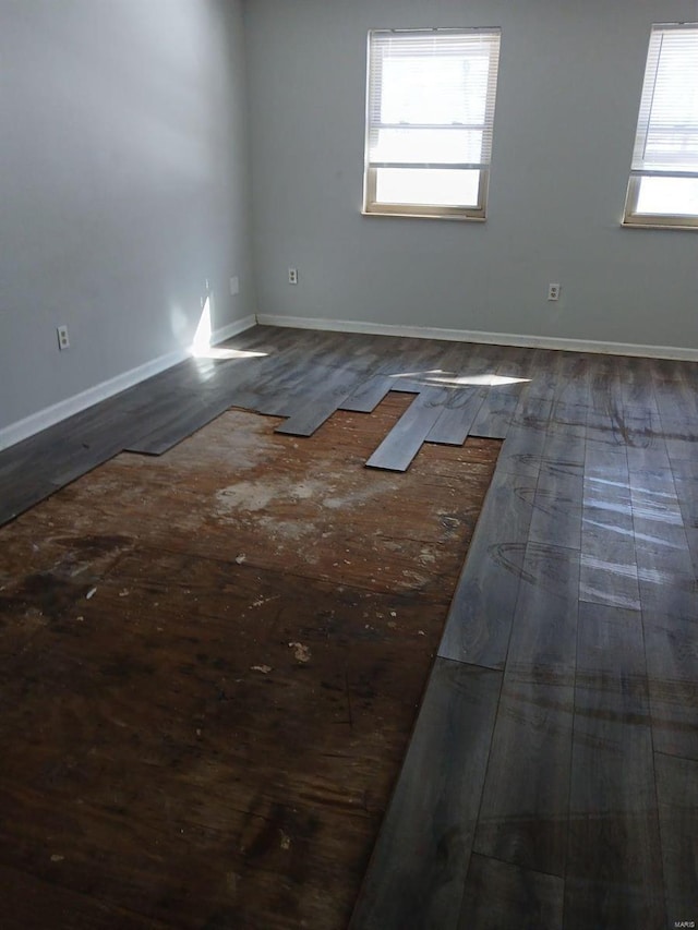 empty room with wood finished floors and baseboards