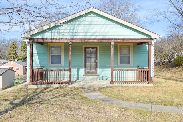 view of front of property with a porch and a front yard