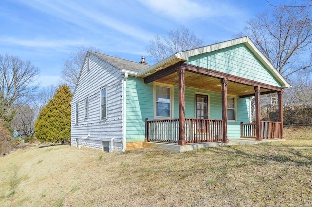 bungalow-style home featuring covered porch and a shingled roof