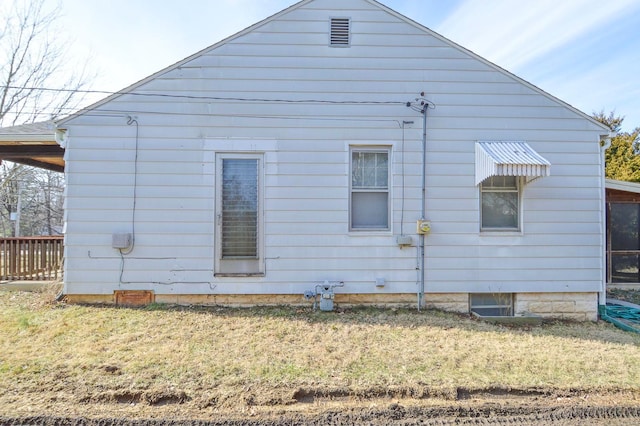 view of side of home featuring a lawn