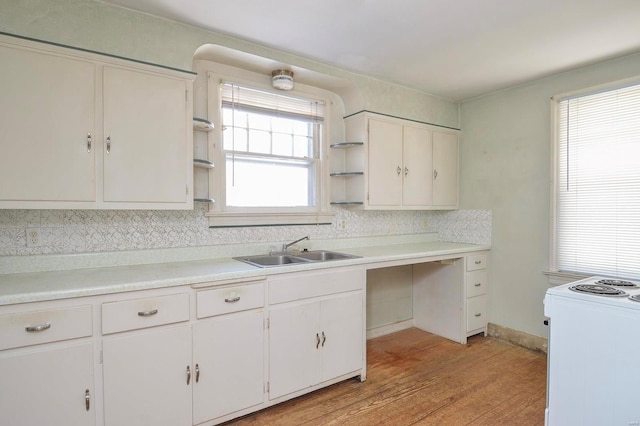 kitchen featuring a sink, open shelves, light wood-style floors, and white range with electric cooktop