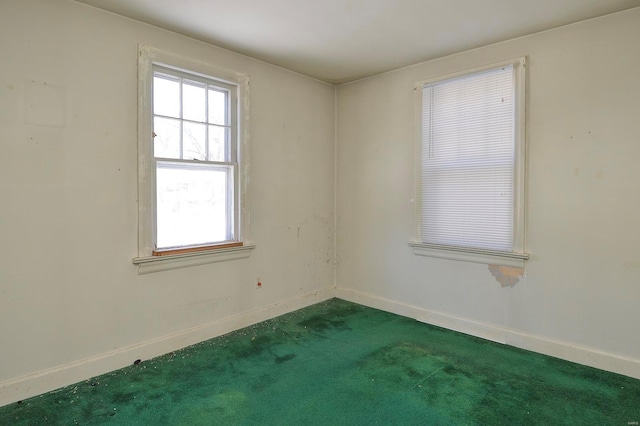 carpeted spare room with baseboards