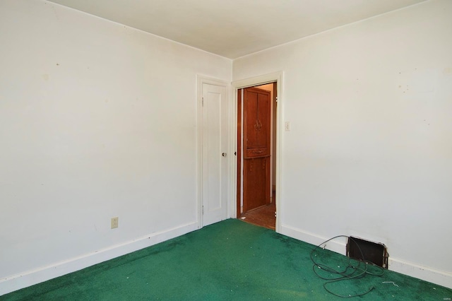 carpeted empty room with baseboards