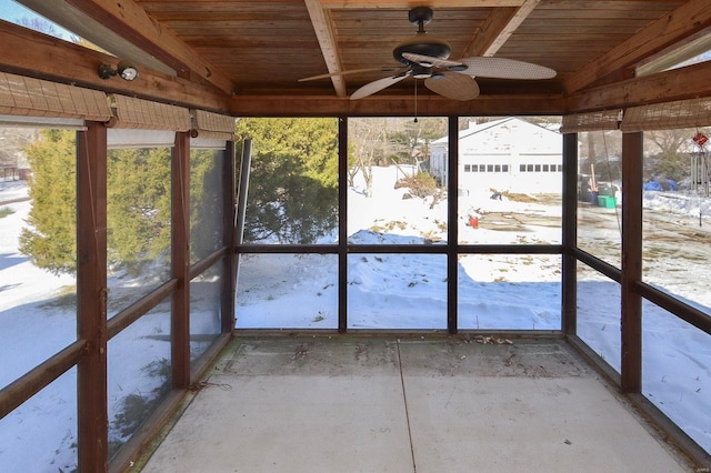 unfurnished sunroom featuring ceiling fan