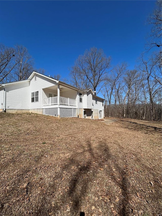 rear view of house featuring a porch