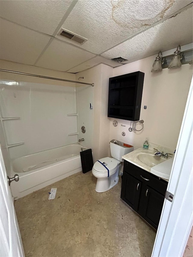 bathroom with vanity, visible vents, tub / shower combination, a paneled ceiling, and toilet