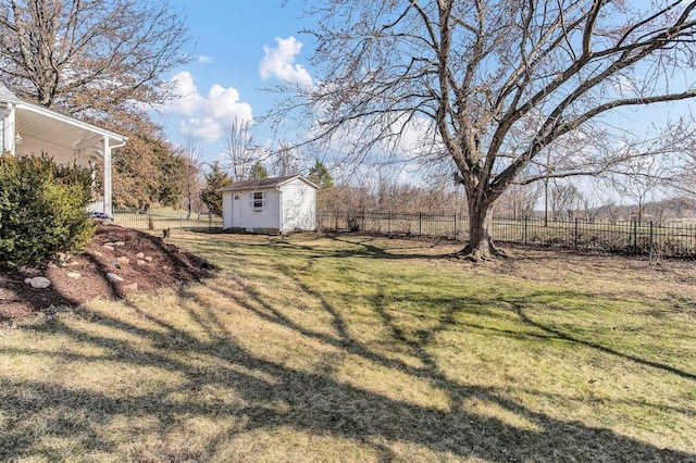 view of yard with a rural view, an outdoor structure, and fence