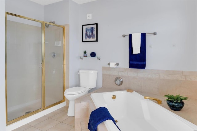 full bathroom featuring tile patterned floors, a shower stall, toilet, and a garden tub