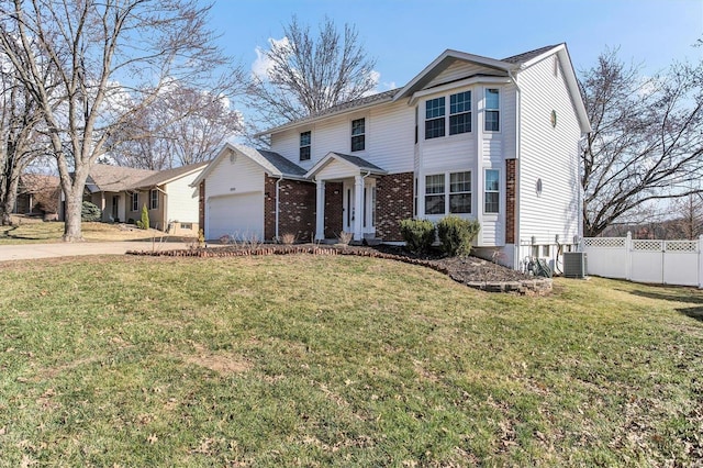 traditional-style house with brick siding, a front lawn, fence, a garage, and driveway