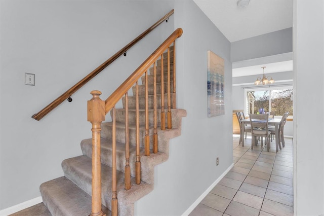 stairway featuring baseboards, a chandelier, and tile patterned flooring