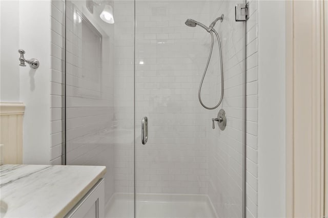 full bathroom with vanity and a shower stall