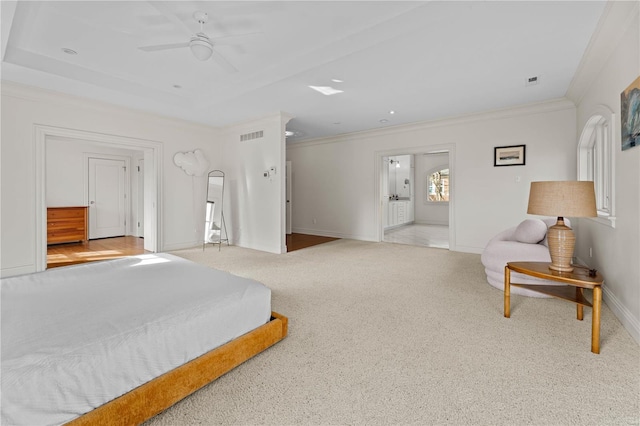 bedroom with a tray ceiling, crown molding, baseboards, and carpet floors