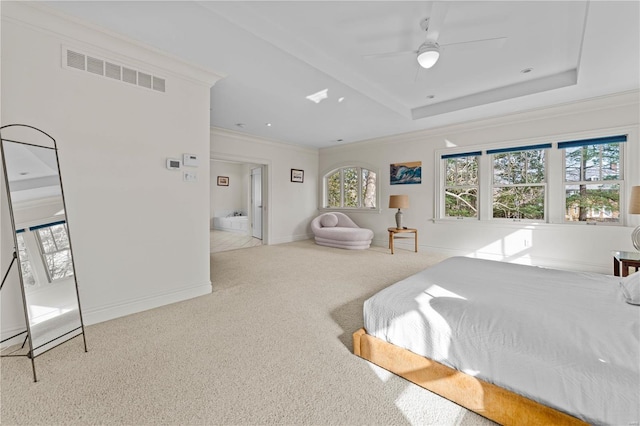 bedroom featuring visible vents, a tray ceiling, carpet, crown molding, and baseboards