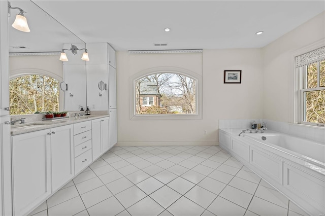 full bath featuring visible vents, baseboards, double vanity, tile patterned floors, and a sink