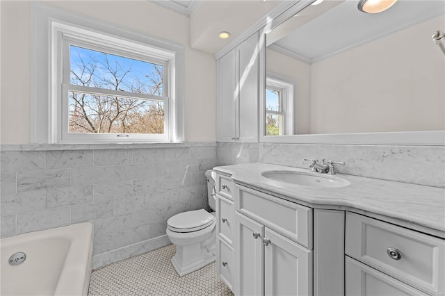 bathroom with a healthy amount of sunlight, toilet, and crown molding