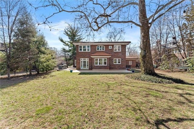 back of house with a patio, a yard, fence, and brick siding