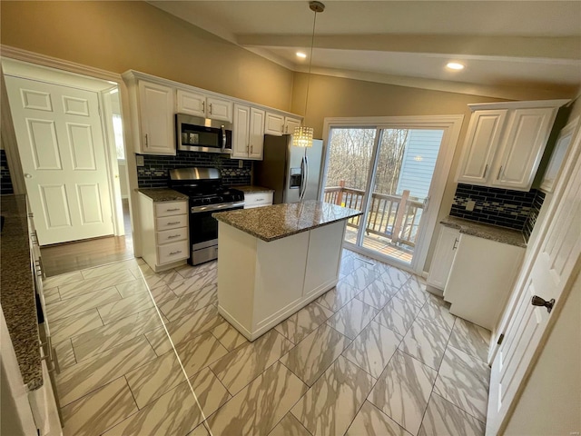 kitchen with a kitchen island, vaulted ceiling, stainless steel appliances, marble finish floor, and white cabinetry