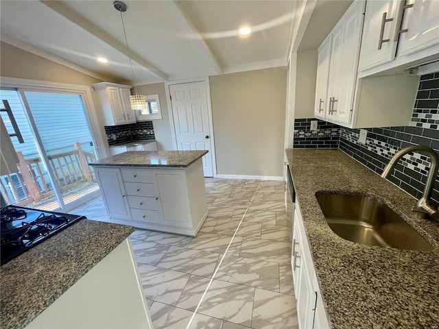 kitchen featuring backsplash, a center island, lofted ceiling, marble finish floor, and a sink