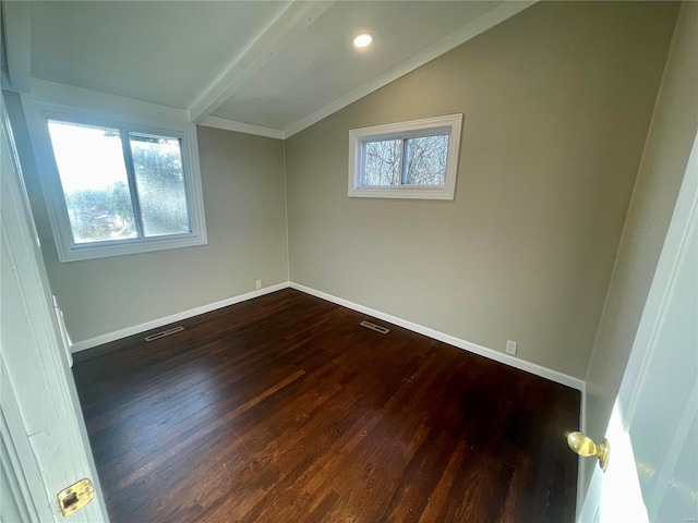 additional living space featuring dark wood finished floors, visible vents, vaulted ceiling with beams, and baseboards