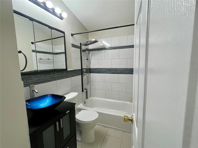 bathroom with vanity, tile patterned flooring, tile walls, toilet, and shower / bathtub combination