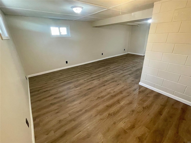 basement featuring dark wood-style floors and baseboards