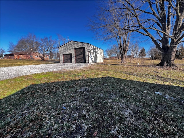 view of yard featuring an outbuilding and a garage