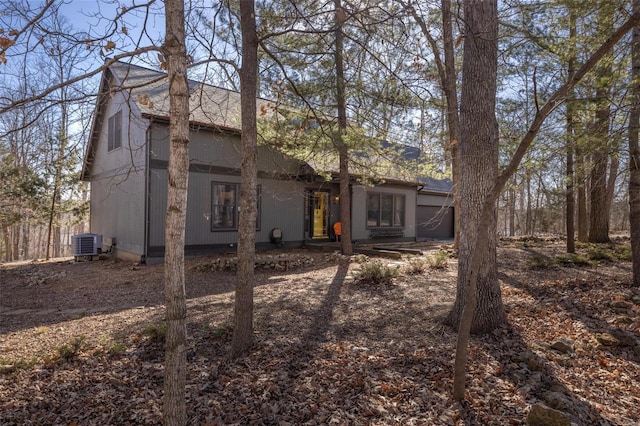 back of house with covered porch and central AC unit