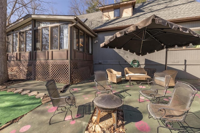 view of patio featuring an outdoor living space, fence, and a sunroom