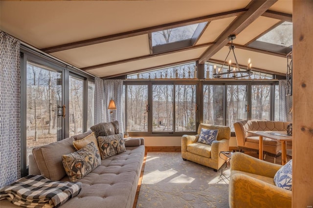 sunroom / solarium featuring a chandelier, vaulted ceiling with skylight, and a healthy amount of sunlight