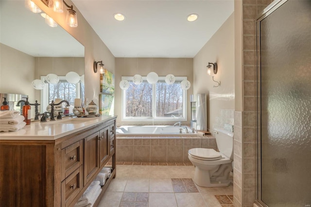 full bathroom with vanity, a bath, a tile shower, tile patterned flooring, and toilet