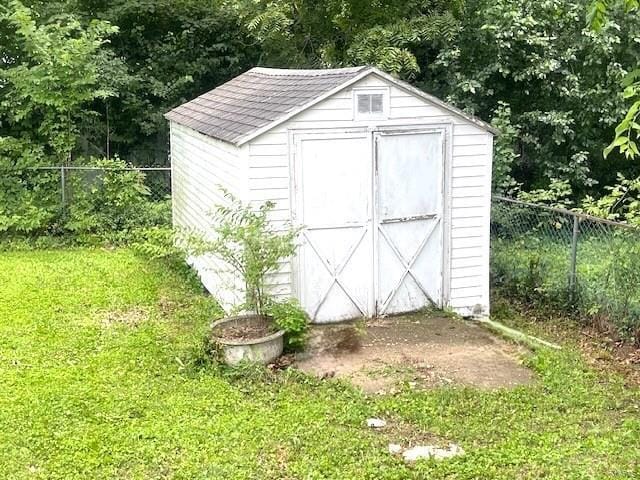 view of shed with fence