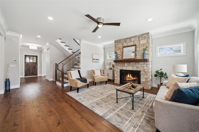 living room with stairs, hardwood / wood-style flooring, plenty of natural light, and crown molding