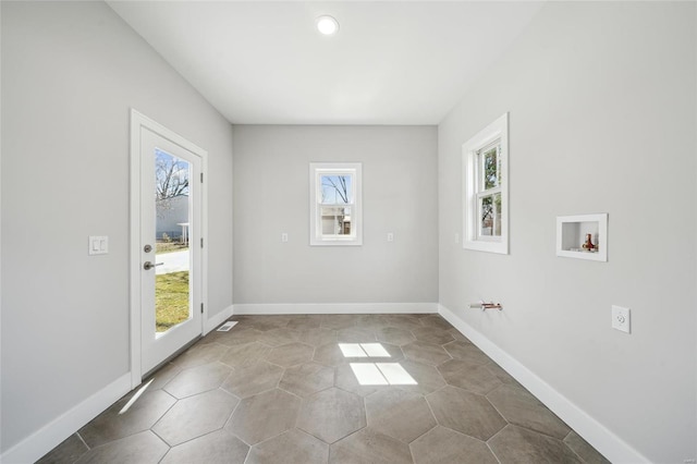 unfurnished room featuring baseboards