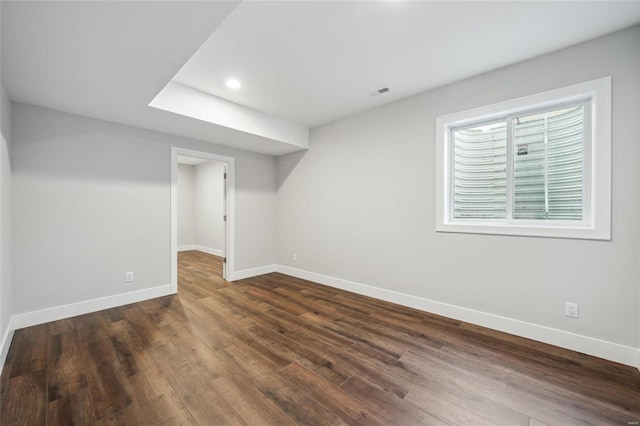 empty room with recessed lighting, visible vents, baseboards, and dark wood-type flooring